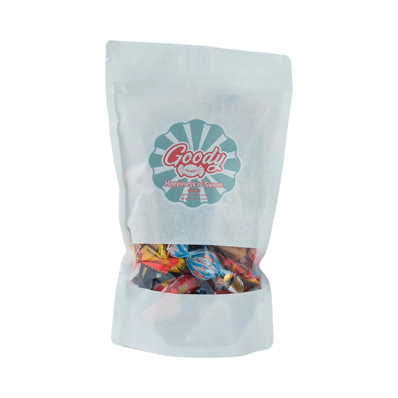 White bag with assorted wrapped candy and chocolate.