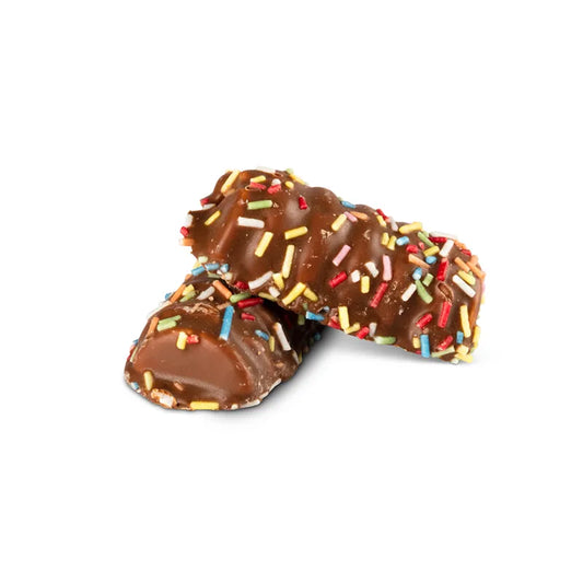 Loaf-shaped foam candy coated in milk chocolate and covered with color sprinkles.