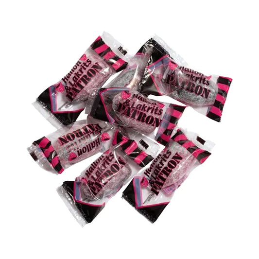 Black and pink bullet-shaped hard caramels in transparent wrapping.